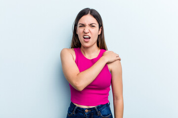 Young caucasian woman isolated on blue background having a shoulder pain.