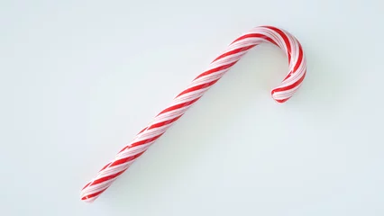 Tuinposter Red-white Christmas candy cane on white background. © Boxyray