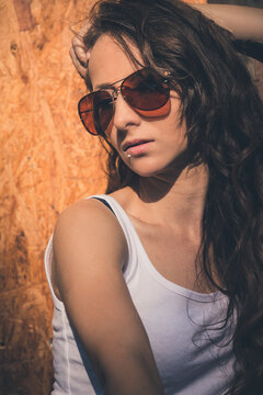 a portrait of a woman with red sunglasses