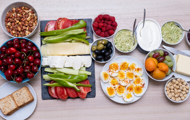Healthy breakfast concept with fresh vegetables, eggs, nuts and fruits