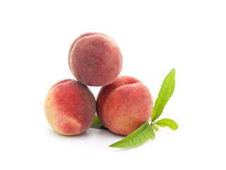 Three ripe peaches with leaves.