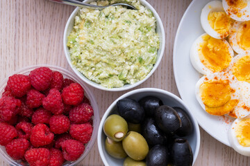 Healthy breakfast concept with fresh vegetables, eggs, nuts and fruits