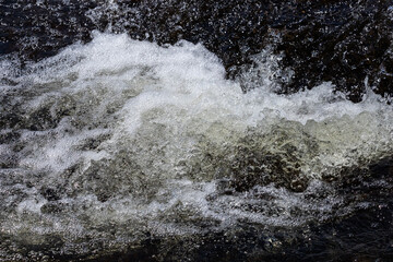 Water flowing into the river, Bright splashes of water