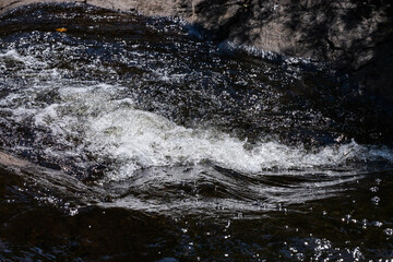 Water flowing into the river, Bright splashes of water