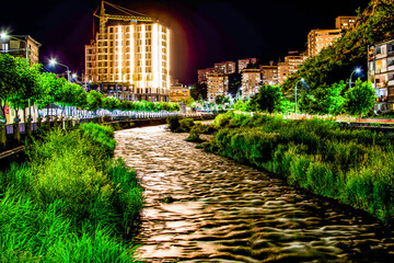 Night city from a bird's eye view. The light of houses and cars. A beautiful city with rivers, bridges and beautiful buildings. City among the mountains, Kapan, Armenia