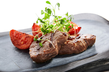 Grilled marbled beef with tomatoes top view
