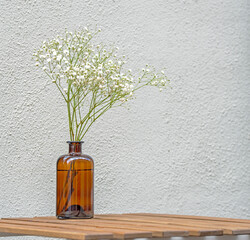 Still Life with minimal floral composition on wooden table at a street cafe