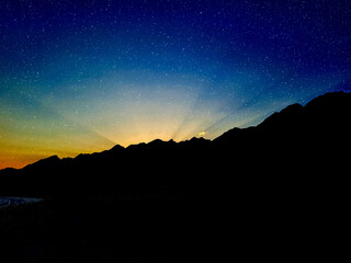 Fototapeta na wymiar Night landscape of mountains with blue stellar sky natural background and wallpaper
