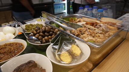Traditional Thai dessert called Khao Tom Mud, sticky rice with banana wrapped in banana leaves, representing Thai sweets, local food, and cultural heritage.