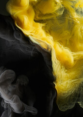 Liquid fluid art abstract background. Black, yellow dancing acrylic paints underwater, space smoke...