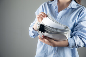 Woman with stack of documents