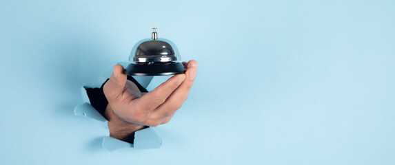 man holding hotel ring bell