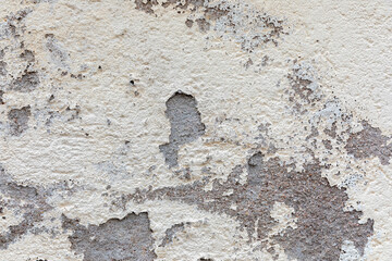 Exterior stucco on an old house is damaged. Exterior finish.