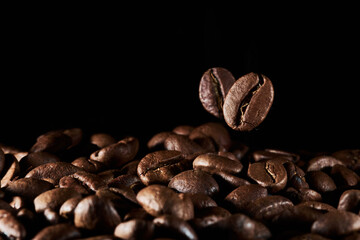 Roasted coffee beans isolated close up on black background, clipping path