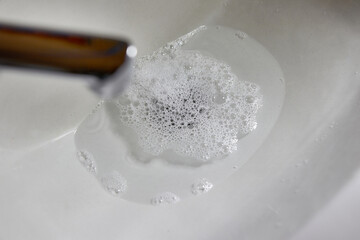 They wash their hands in the sink, the sewer pipe of which is clogged.