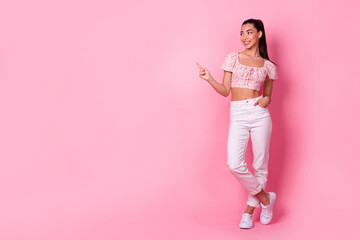 Full body photo of gorgeous lovely girl look direct finger empty space proposition isolated on pink color background