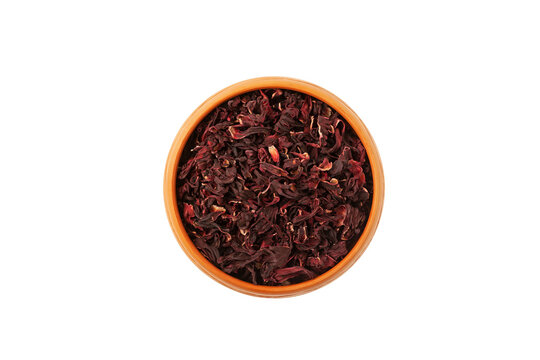 Dried hibiscus petals or Hibiscus sabdariffa in clay plate, top view. Karkade petals used to make delicious herbal  tea. Sudanian rose