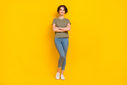 Photo of confident pretty girl dressed green t-shirt smiling arms crossed isolated yellow color background