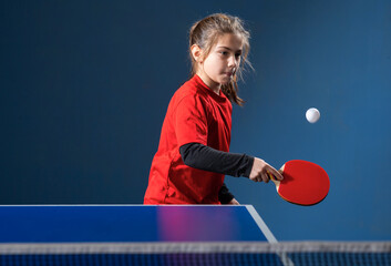  girl child plays ping pong on indoor - obrazy, fototapety, plakaty