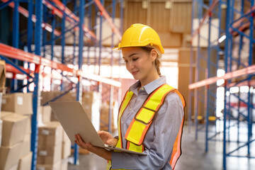 Portrait of female worker using laptop working in warehouse, Industrial and industrial workers...