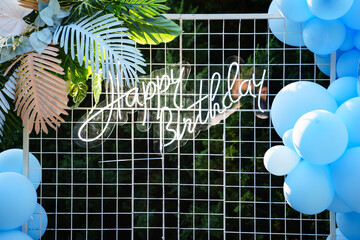 blue balloons and led lettering. photo zone and decorations for the holiday.