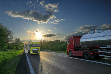 Landscape with a moving truck on the highway at sunset.