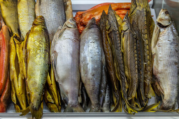 Fototapeta premium Salted fish and cold smoked fish on counter in store