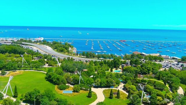 Aerial flyby shot of Lake Michigan next to Pritzker Pavilion in Chicago Illinois | Afternoon Lighting