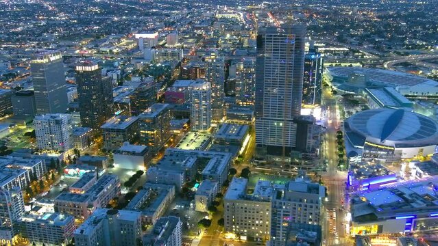 Aerial flyby of downtown Los Angeles in evening time.
