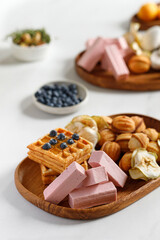 Wooden dish with sweets, waffles and pastilles. Natural sweets. Apple chips.