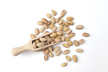 wooden scoop of pistachio isolated on white