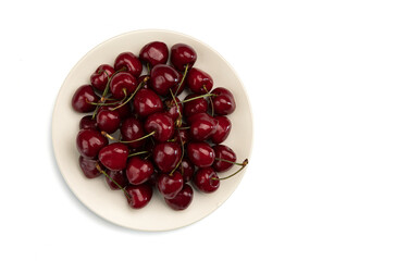 red sweet cherries on plate isolated on white