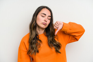 Young caucasian woman isolated on white background showing a dislike gesture, thumbs down....
