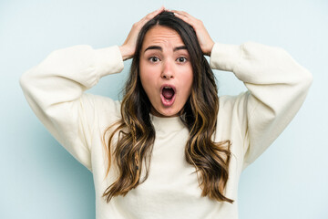 Fototapeta premium Young caucasian woman isolated on blue background surprised and shocked.