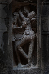 A sculpture of a couple in a romantic mood at Ellora Caves of Maharashtra, India.