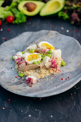 Oatmeal with boiled egg, bacon and green peas. Healthy and tasty breakfast