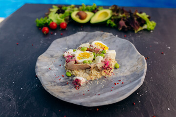 Oatmeal with boiled egg, bacon and green peas. Healthy and tasty breakfast