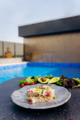 Oatmeal with boiled egg, bacon and green peas. Healthy and tasty breakfast