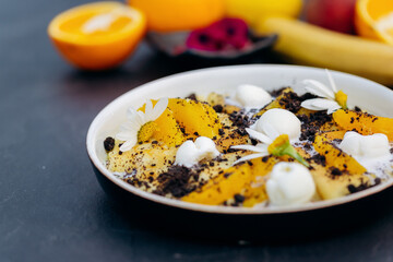 Sweet pancakes with ice cream, chocolate and orange served on white plate. Healthy and tasty breakfast