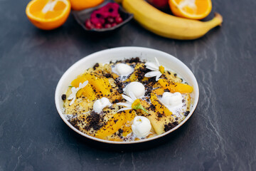 Sweet pancakes with ice cream, chocolate and orange served on white plate. Healthy and tasty breakfast