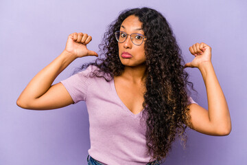 Young hispanic woman isolated on purple background feels proud and self confident, example to follow.