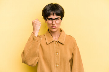 Young caucasian woman with a short hair cut isolated showing fist to camera, aggressive facial expression.
