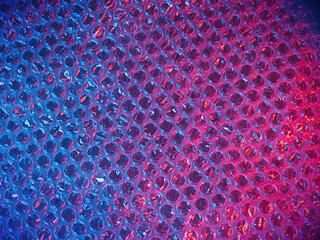 Air bubble wrap, protective plastic sheet in a retro purple aesthetic shot. Shiny close up template shot, of a material used for safety on product delivery