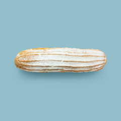 Eclair with powdered sugar on a light blue background. Seamless pattern