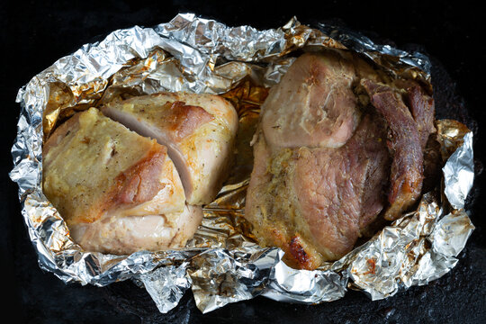 Juicy meat baked in foil just out of the oven.