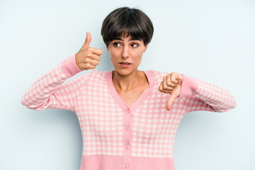 Young caucasian woman with a short hair cut isolated showing thumbs up and thumbs down, difficult...