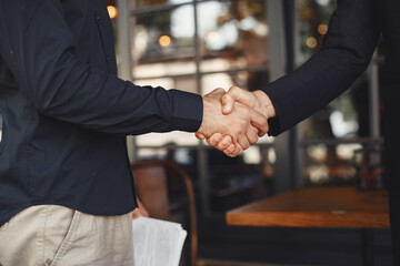 Portrait of cheerful young manager handshake with new employee.