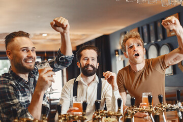 Three men in shirts in the bar.