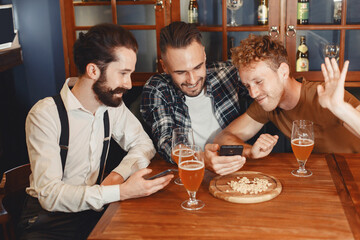 Three men in shirts in the bar.