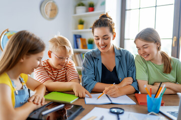 Happy kids and teacher at school